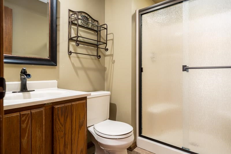 10077 Jesters Row Roscoe, IL 61073 - Photo 24 of 61 a bathroom with a sink a toilet a mirror and shower