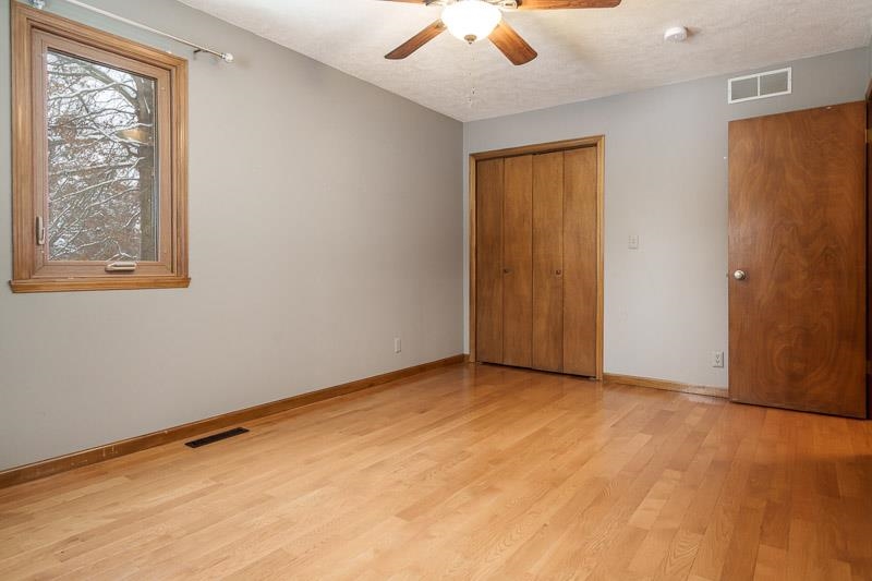 10077 Jesters Row Roscoe, IL 61073 - Photo 30 of 61 an empty room with a window and a ceiling fan