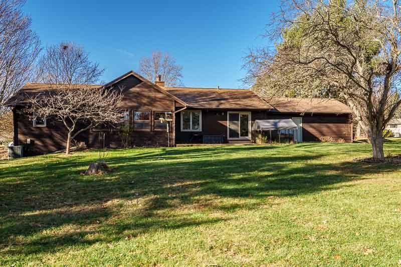 10077 Jesters Row Roscoe, IL 61073 - Photo 49 of 61 a front view of a house with a garden and trees