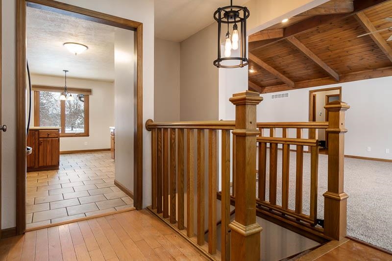 10077 Jesters Row Roscoe, IL 61073 - Photo 5 of 61 a view of a hallway with wooden floor and staircase