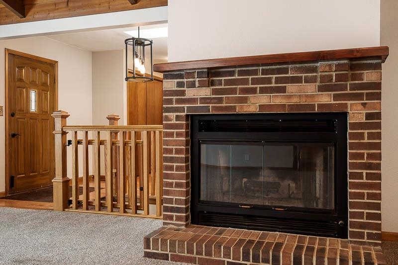 10077 Jesters Row Roscoe, IL 61073 - Photo 8 of 61 a view of fireplace with wooden floor