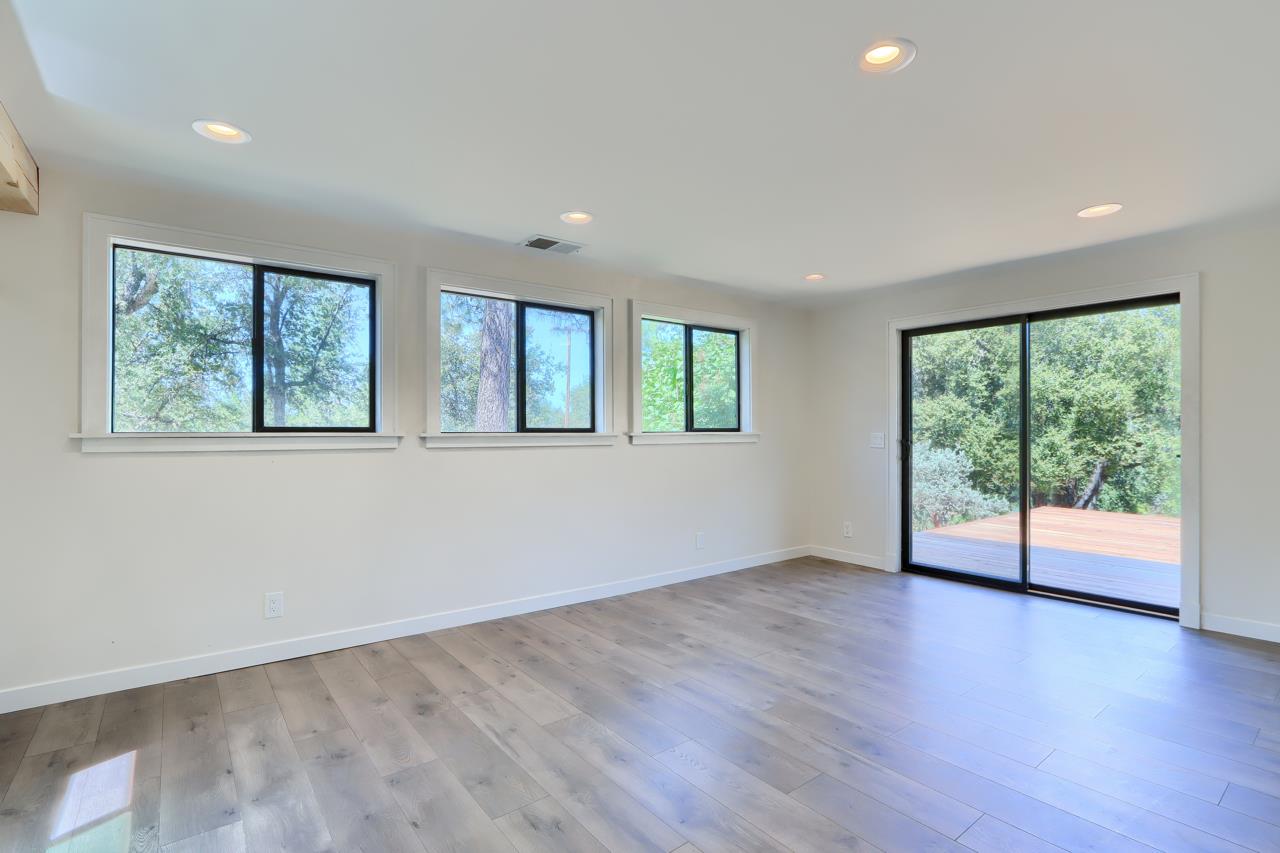 3318 Triangle Road Mariposa, CA 95338 - Photo 19 of 49 an empty room with wooden floor and windows