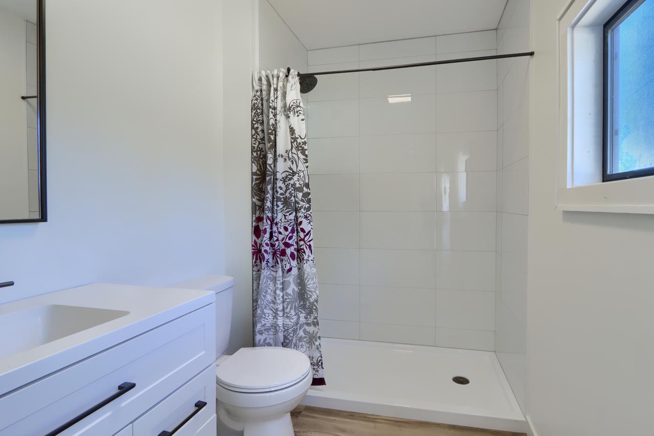 3318 Triangle Road Mariposa, CA 95338 - Photo 30 of 49 a bathroom with a shower curtain and a toilet