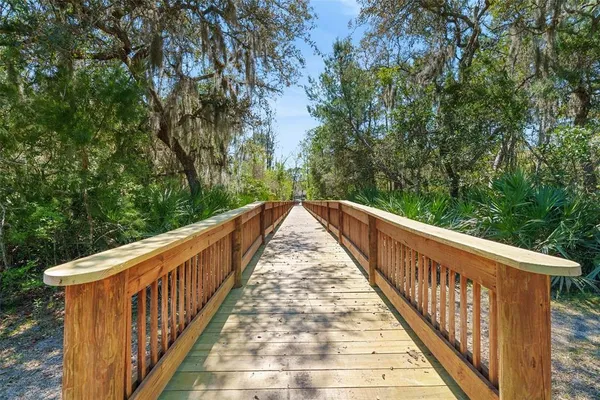 an aerial view of a house with a yard and lake view