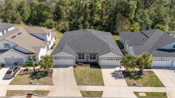 an aerial view of a house with a yard