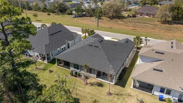 an aerial view of a house with a yard and lake view