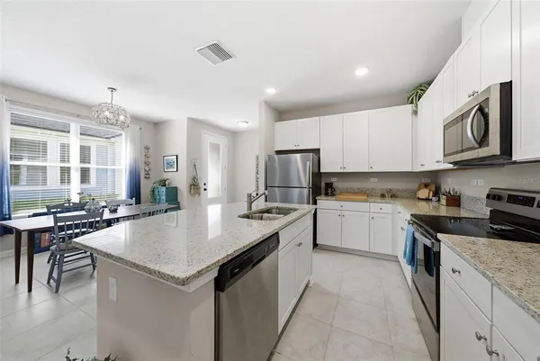 a kitchen with a refrigerator and a sink