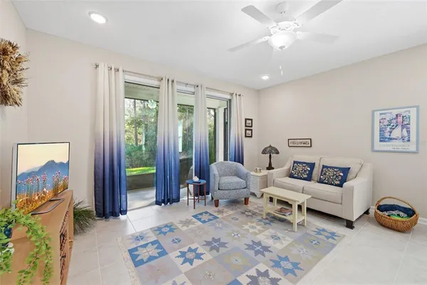 a living room with furniture and a view of kitchen