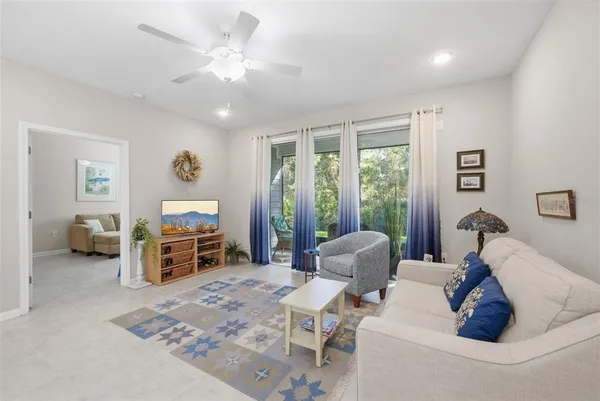 a living room with stainless steel appliances kitchen island granite countertop furniture and a dining table with kitchen view