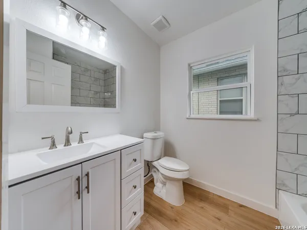 a bathroom with a sink toilet and vanity
