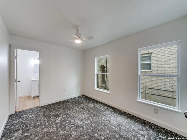 a bathroom with a toilet a sink a mirror and bathtub