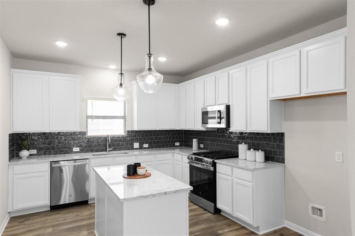 717 Paddock Lane Georgetown, TX 78626 - Photo 2 of 34 a kitchen with a sink stove and cabinets