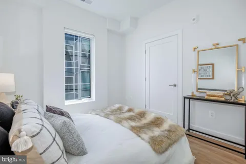 a bedroom with a bed and a window