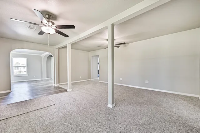 a view of a livingroom with a ceiling fan and window