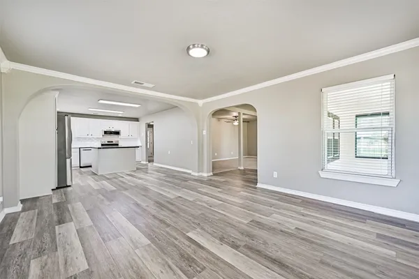 a view of a room with wooden floor and a window