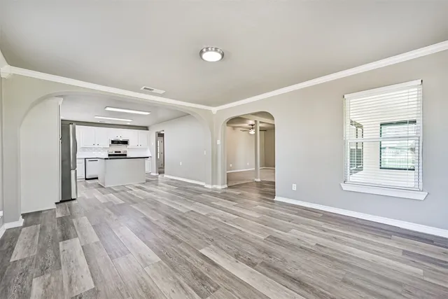 a view of a room with wooden floor and a window