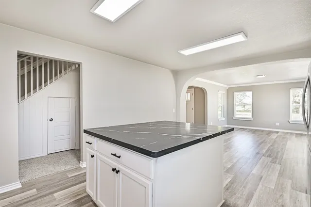 a view of a kitchen counter space and wooden floor