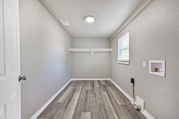 a view of a room with wooden floor and window