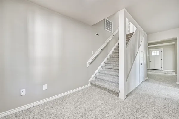 a view of a hallway with staircase