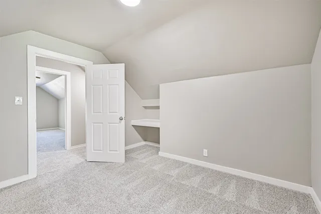 an empty room with a window and a ceiling fan