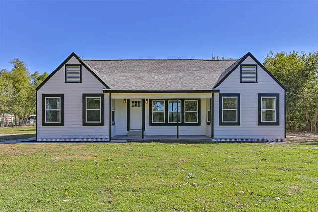 a front view of house with yard and green space