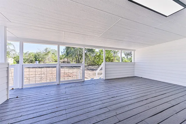 a view of wooden floor and brick walls