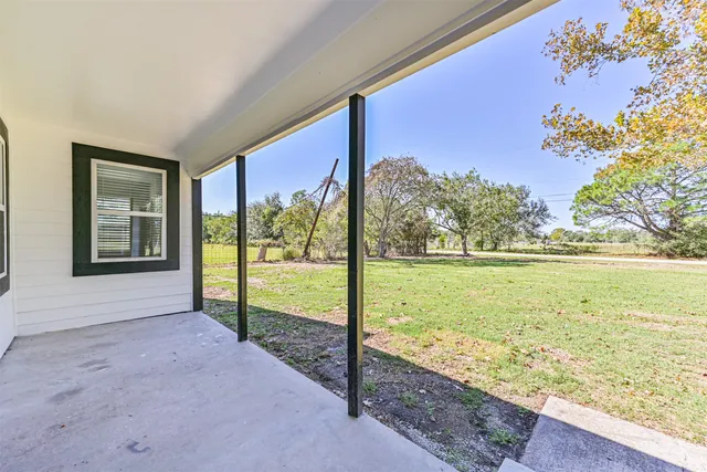 a view of ocean with a floor to ceiling window and wooden floor