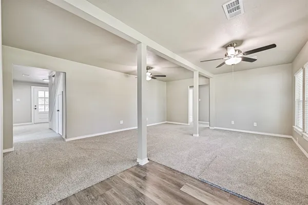 a view of an empty room with a ceiling fan