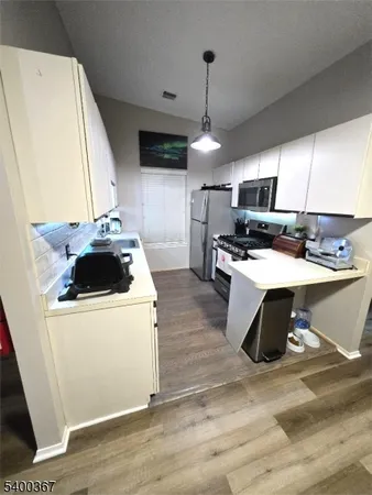 a kitchen with a stove a sink and a refrigerator