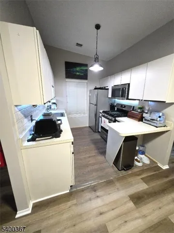 a kitchen with a stove a sink and a refrigerator