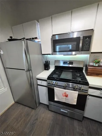 a stove top oven sitting inside of a kitchen