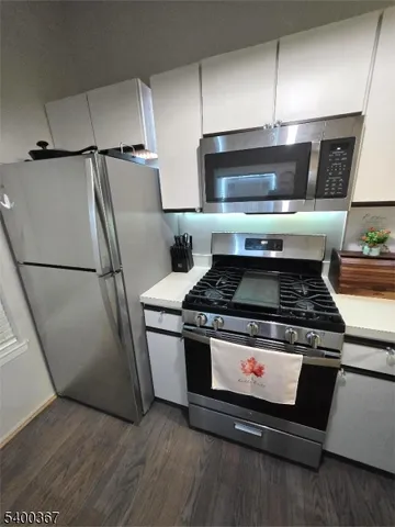 a stove top oven sitting inside of a kitchen