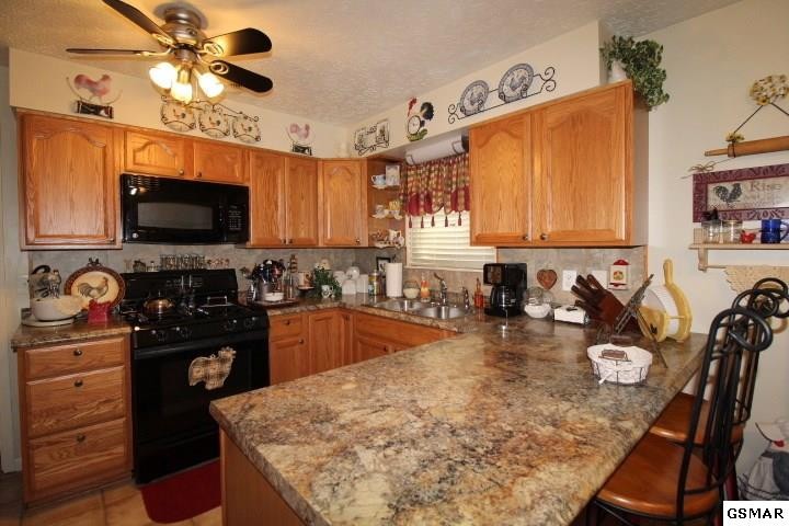 1822 New Era Road Sevierville, TN 37862 - Photo 7 of 34 a kitchen with sink a stove and cabinets