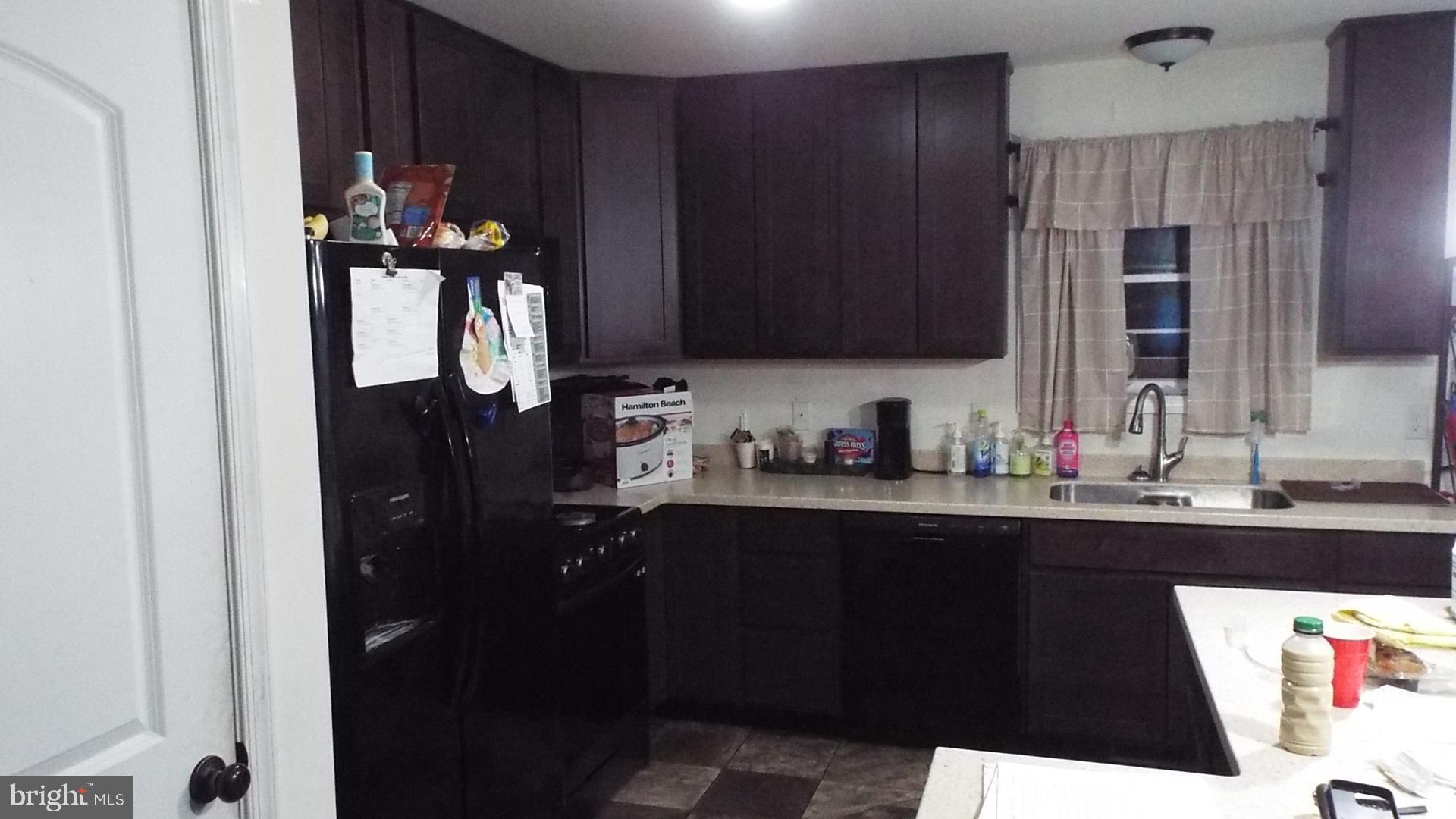 717 Bethayres Street Harrington, DE 19952 - Photo 4 of 7 a kitchen with a sink and cabinets