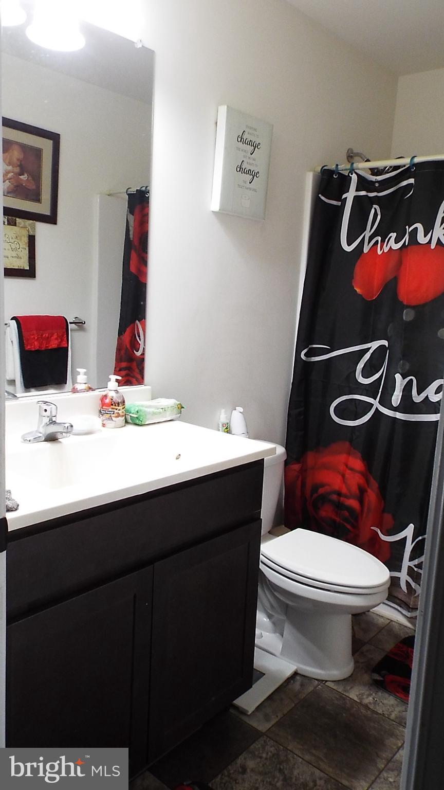 717 Bethayres Street Harrington, DE 19952 - Photo 5 of 7 a bathroom with a sink toilet and mirror