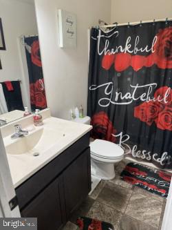 717 Bethayres Street Harrington, DE 19952 - Photo 7 of 11 a bathroom with a sink a toilet and a mirror
