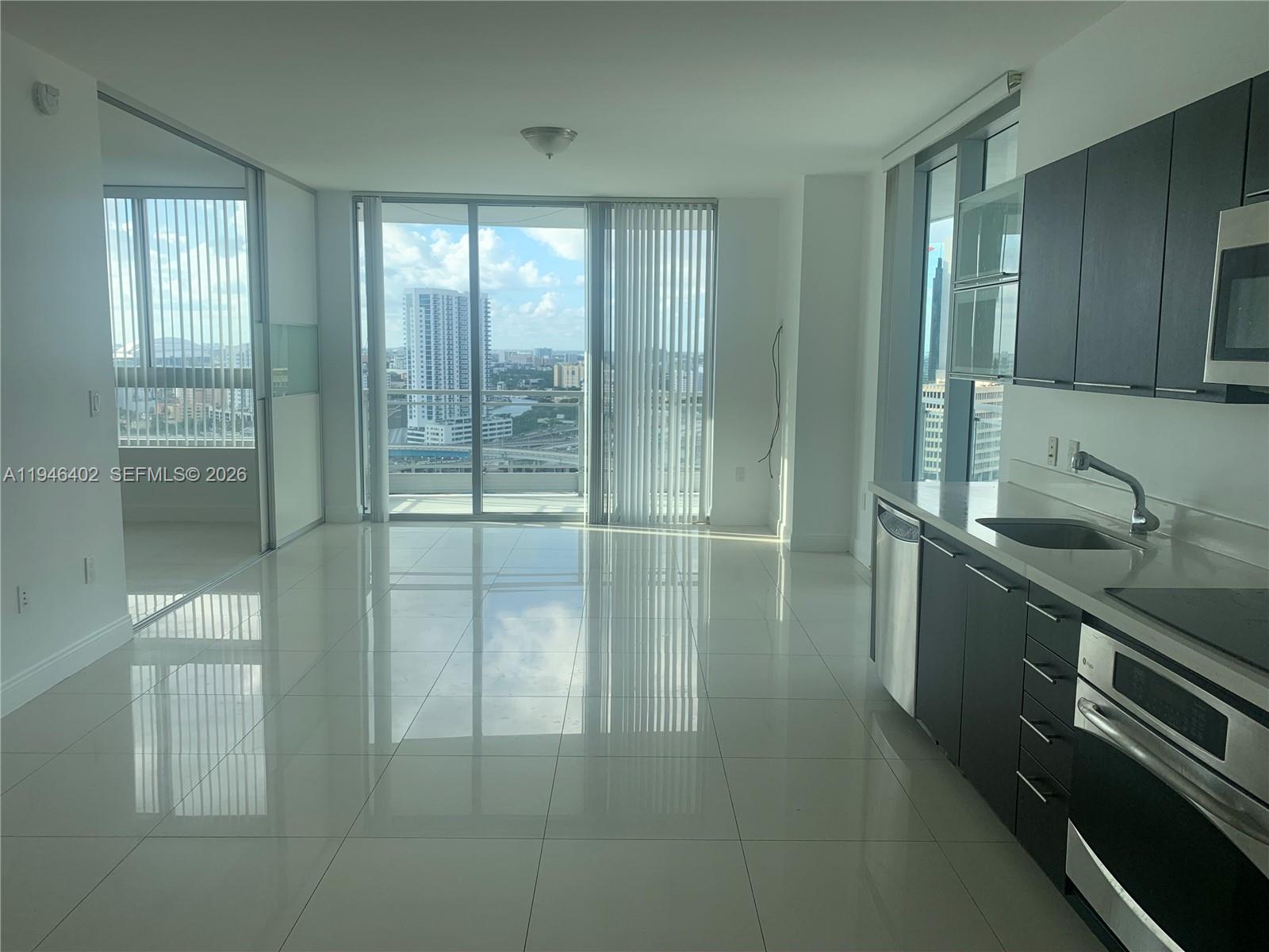 90 Southwest 3rd Street, Unit 2305 Miami, FL 33130 - Photo 7 of 13 a bathroom with double vanity and a shower