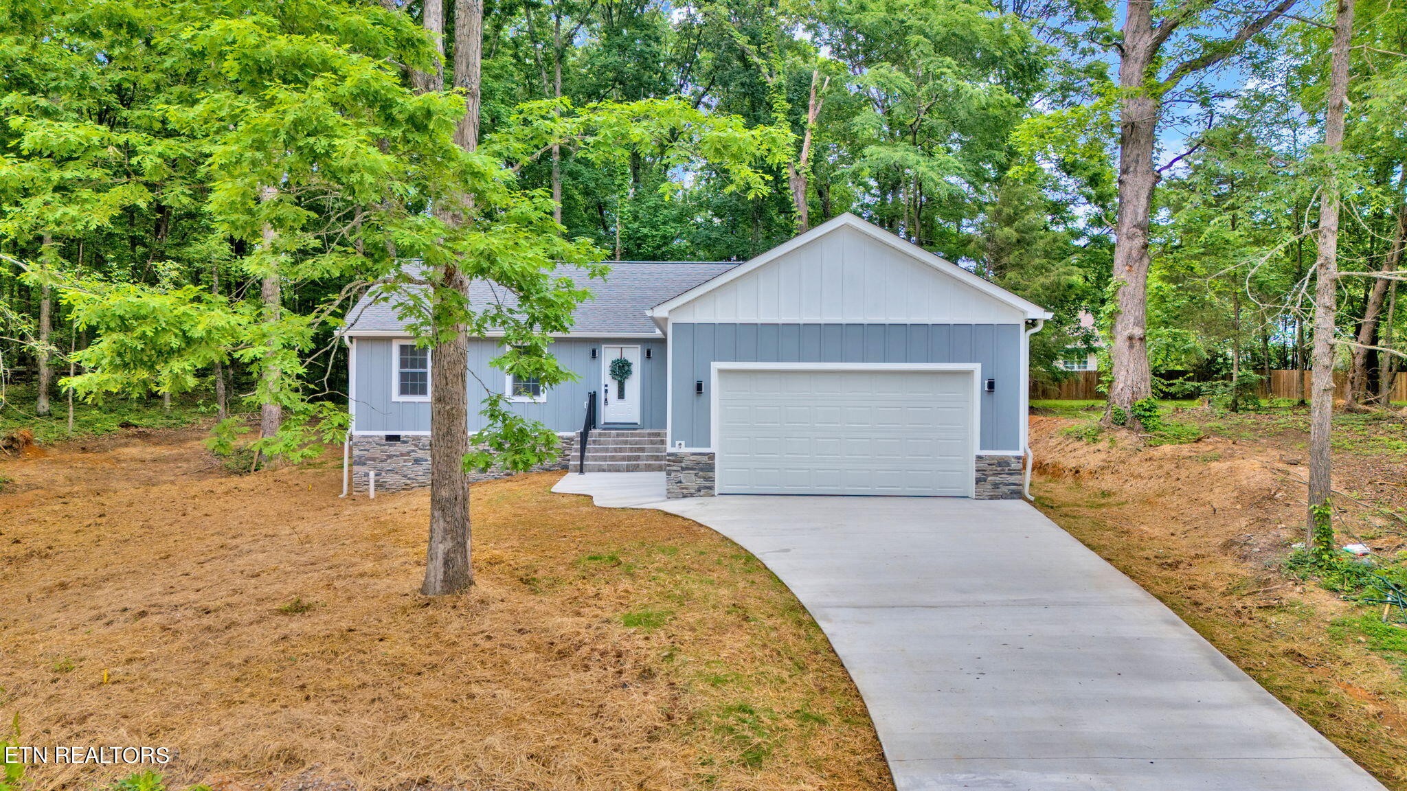 159 Country Way Road Vonore, TN 37885 - Photo 1 of 32 a front view of a house with a yard and garage