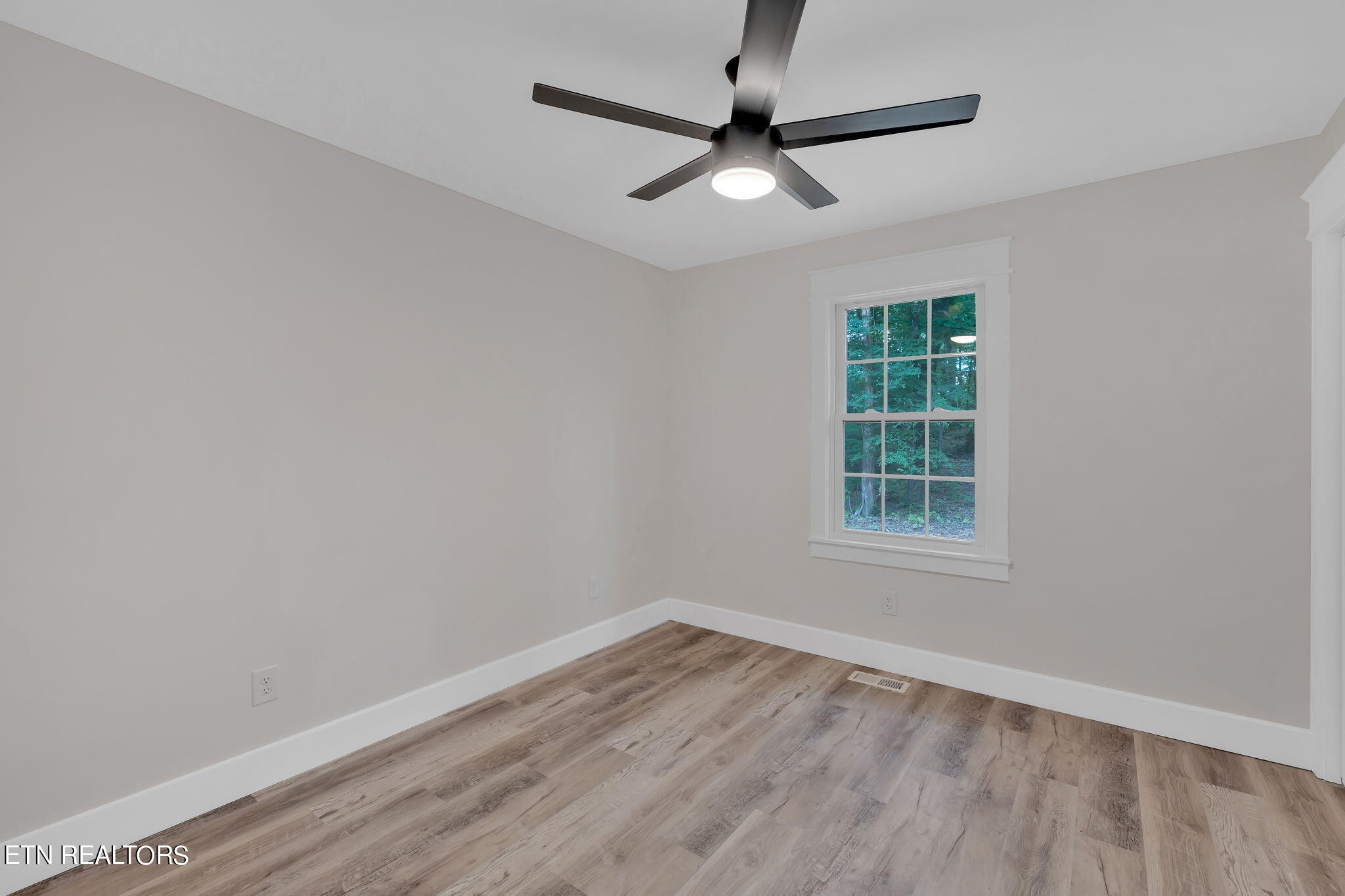 159 Country Way Road Vonore, TN 37885 - Photo 21 of 32 an empty room with wooden floor and windows