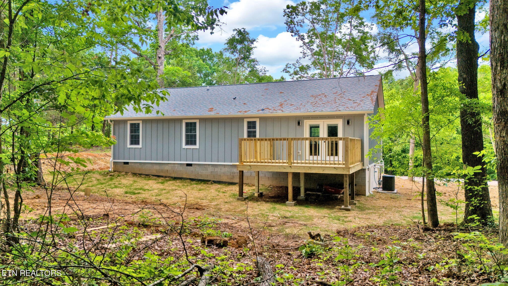 159 Country Way Road Vonore, TN 37885 - Photo 5 of 32 a house that has a big tree in the background with wooden fence