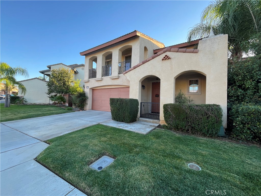 1483 Albillo Loop Perris, CA 92571 - Photo 1 of 46 a front view of a house with a yard