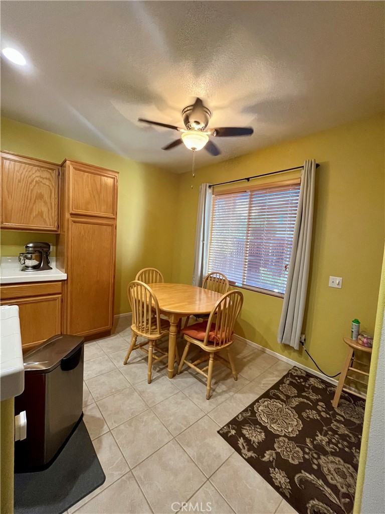 1483 Albillo Loop Perris, CA 92571 - Photo 12 of 46 a dining room with furniture and a chandelier