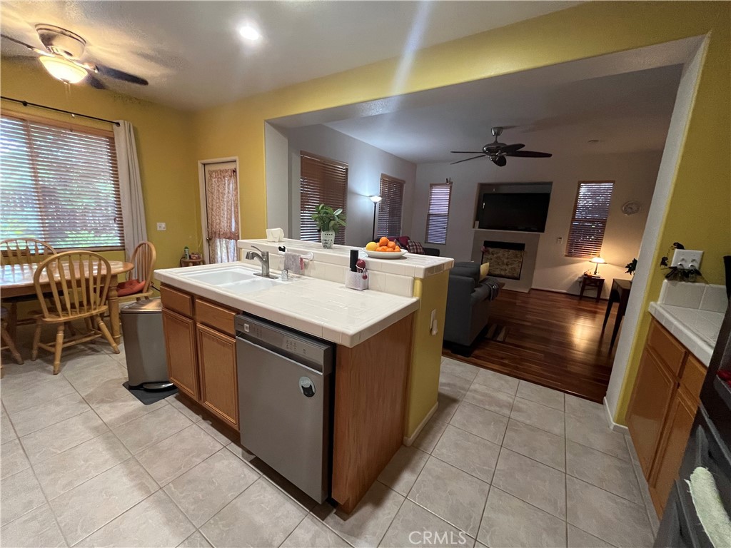 1483 Albillo Loop Perris, CA 92571 - Photo 13 of 46 a kitchen with a sink stove and cabinets