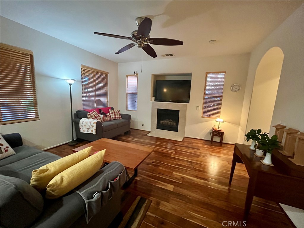 1483 Albillo Loop Perris, CA 92571 - Photo 15 of 46 a bedroom with furniture and a fireplace