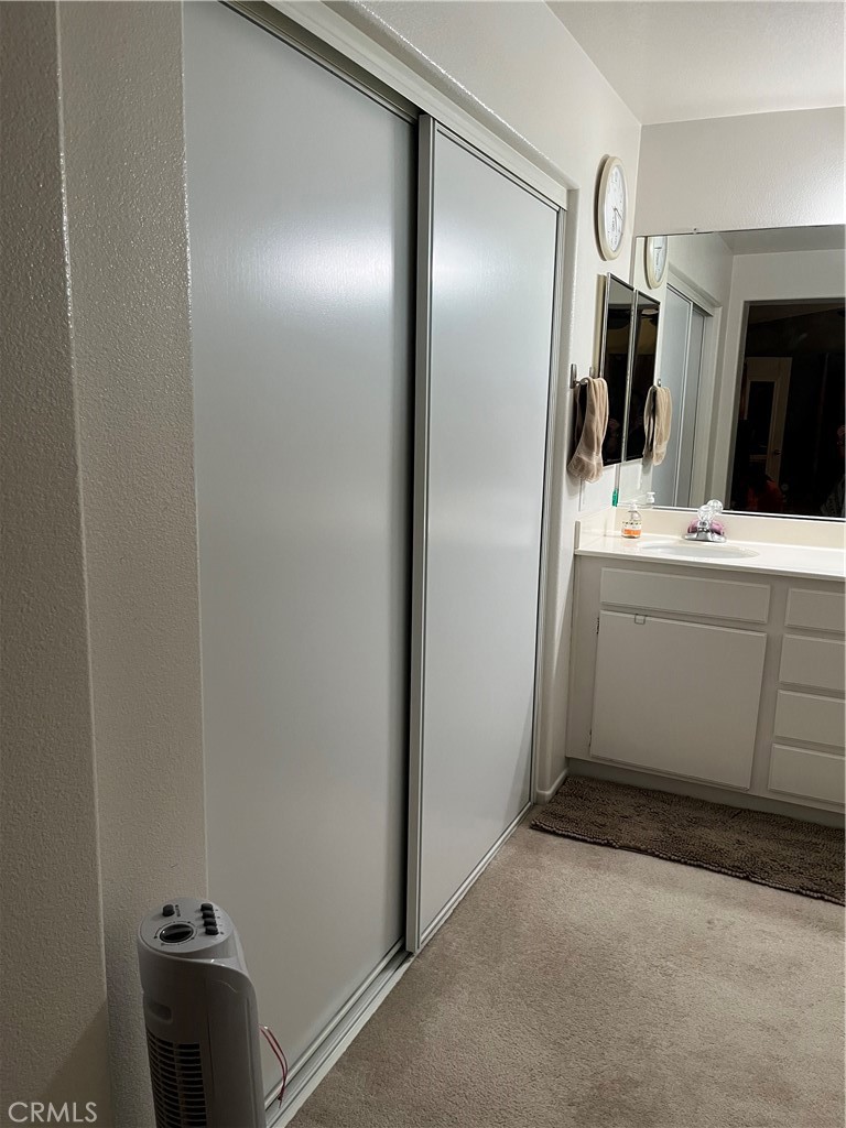 1483 Albillo Loop Perris, CA 92571 - Photo 18 of 46 a bathroom with a sink and mirror