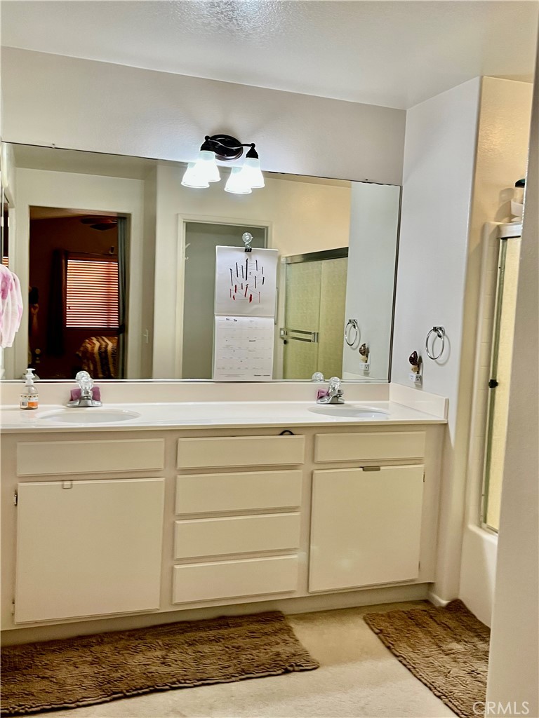 1483 Albillo Loop Perris, CA 92571 - Photo 21 of 46 a bathroom with a sink a mirror and a vanity
