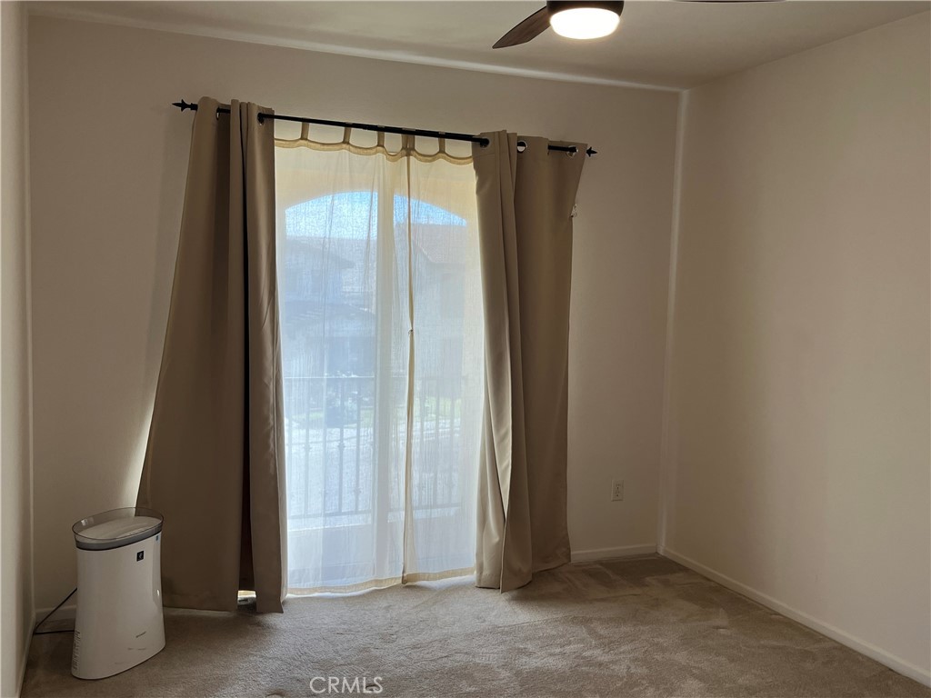 1483 Albillo Loop Perris, CA 92571 - Photo 26 of 46 an empty room with a door