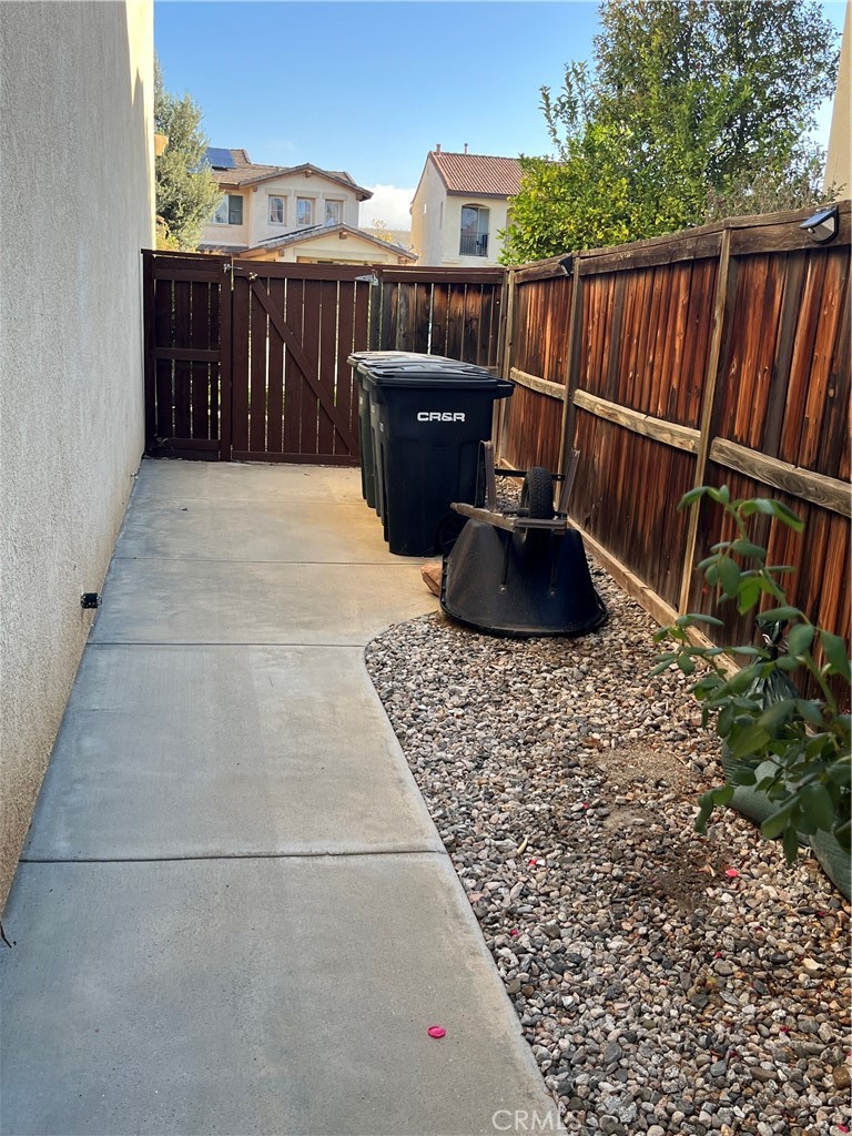 1483 Albillo Loop Perris, CA 92571 - Photo 33 of 46 a view of roof deck with wooden floor and fence