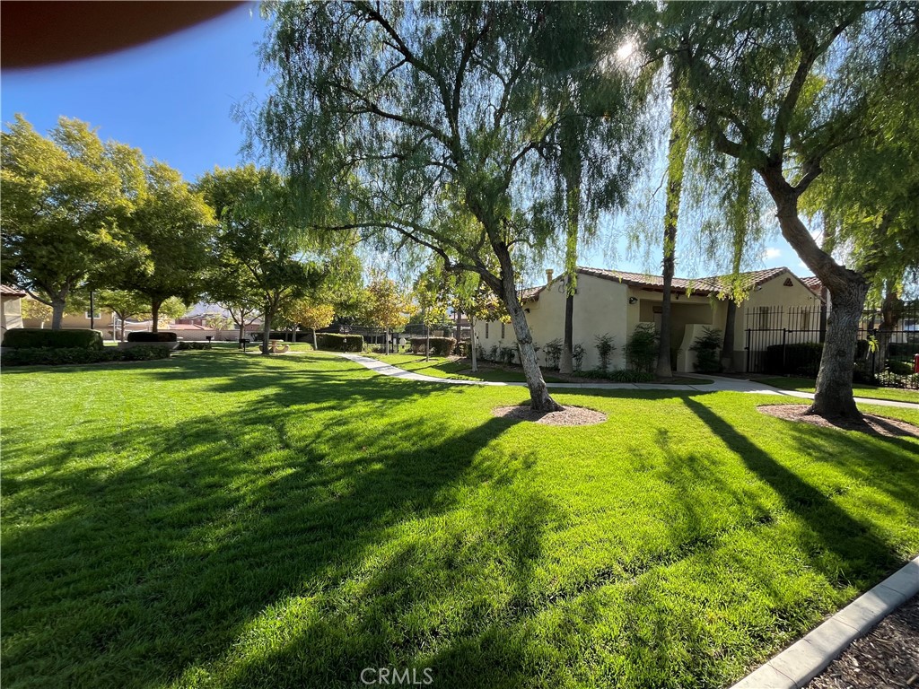 1483 Albillo Loop Perris, CA 92571 - Photo 36 of 46 a swimming pool with outdoor seating and yard