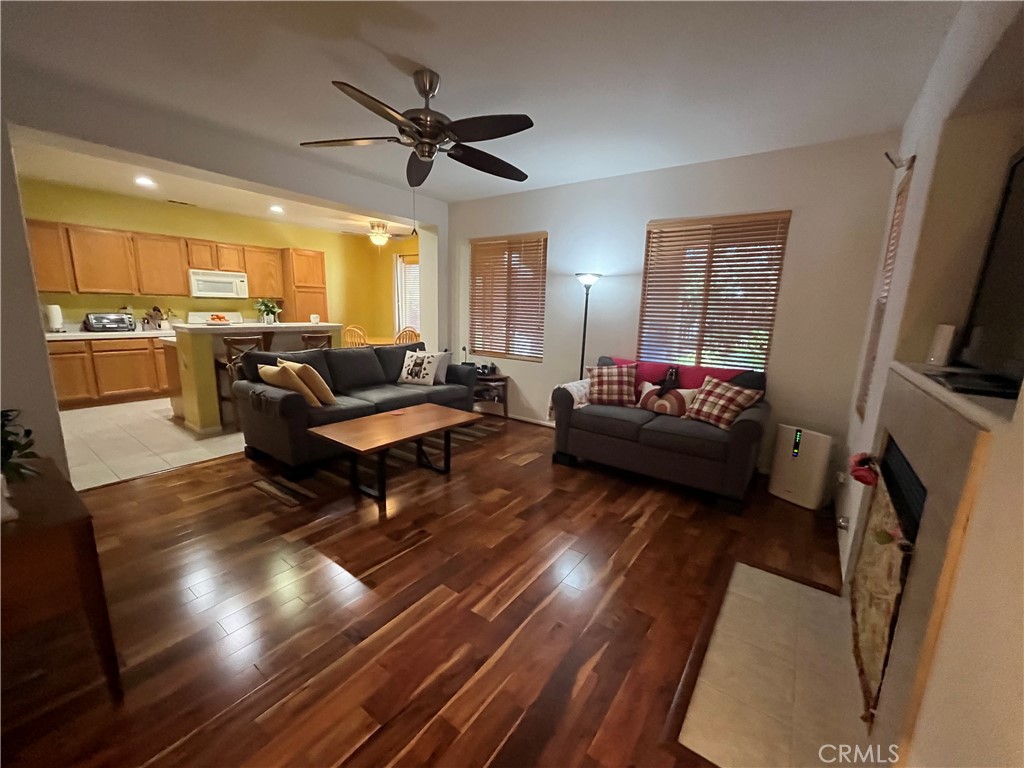 1483 Albillo Loop Perris, CA 92571 - Photo 8 of 46 a living room with furniture and a flat screen tv